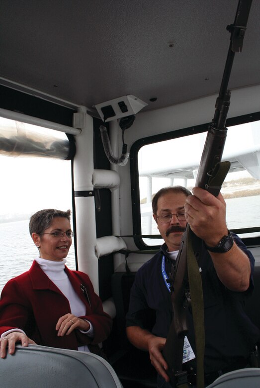 Carla Reinlie, 1st SOW honorary commander from Okaloosa-Walton College, observes Randy Brown, a 1st Special Operations Mission Support Group honorary commander and the Ocean City-Wright Fire Department chief, as he looks at a rifle used by the special operations Airmen at Hurlburt Field. Community leaders serve as honorary commanders to get a better understanding of the base and mission, and how affects the community outside the gates. (Courtesy photo)
