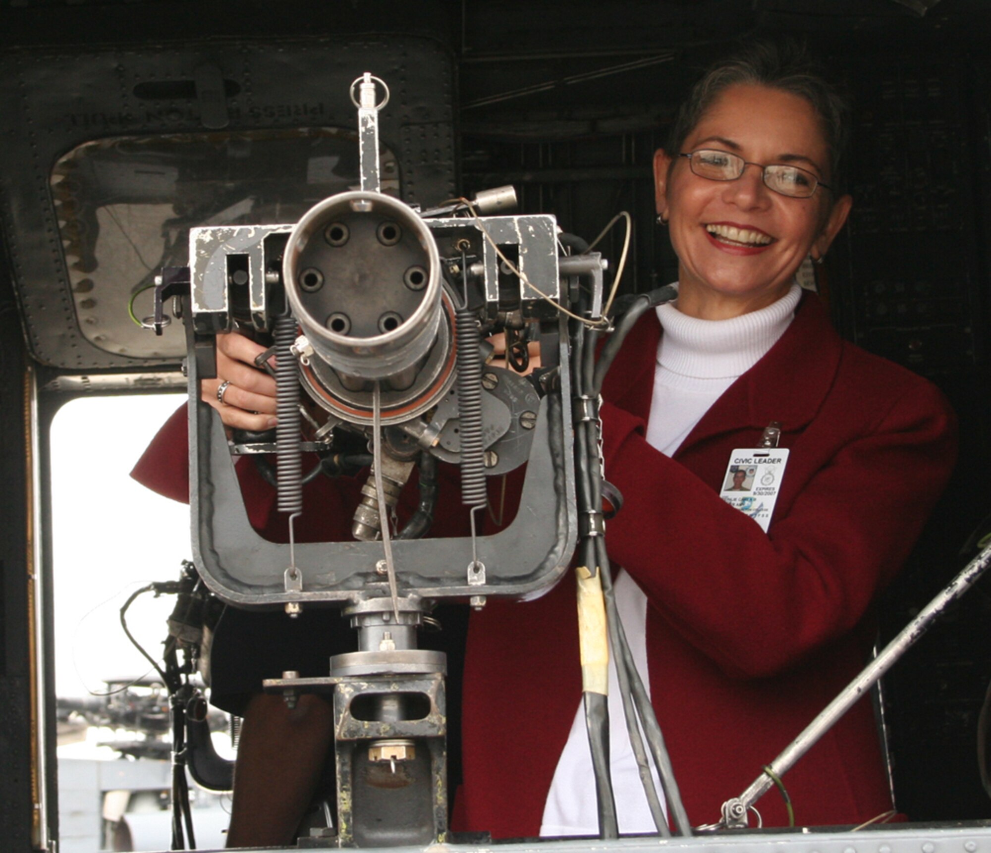 Carla Reinlie, 1st SOW honorary commander from Okaloosa-Walton College, shows her skill at handling the gun on an MH-53 PAVE LOW during a tour. (Courtesy photo)