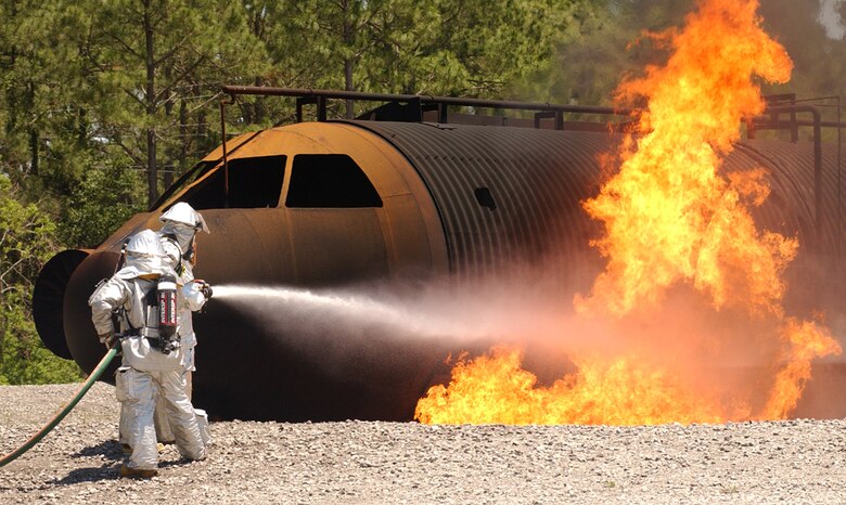 Honorary 1st Special Operations Wing commander Tony Hughes, president and chief executive officer of Beach Community Bank, tries his hand at firefighting during an honorary commander tour. The Honorary Commanders Program is a way for the public to understand Hurlburt Field's mission, and how it might impact the surrounding areas. (Courtesy photo)