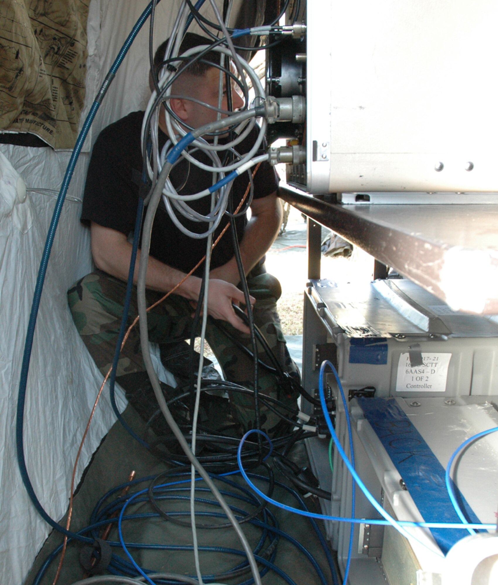 An Airman checks wiring on a computer during Operation Combined Eagle held March 8 at Duke Field. The exercise was a total force communication exercise to get squadrons to work together. (U.S. Air Force photo by Staff Sgt. Mareshah Haynes)