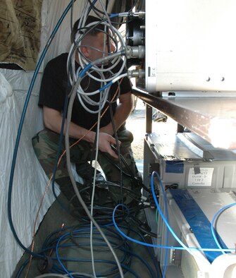 An Airman checks wiring on a computer during Operation Combined Eagle held March 8 at Duke Field. The exercise was a total force communication exercise to get squadrons to work together. (U.S. Air Force photo by Staff Sgt. Mareshah Haynes)