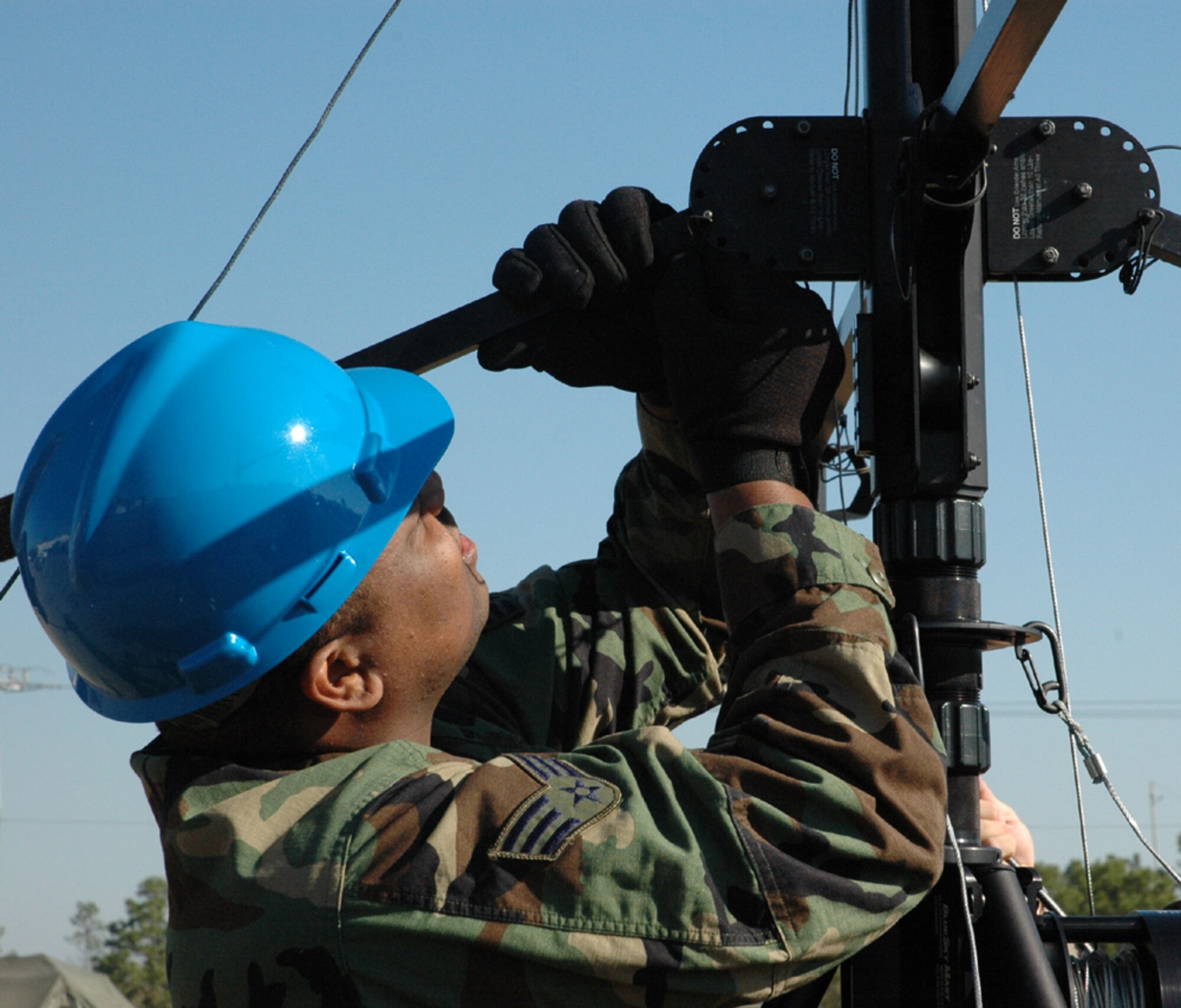 A communication specialist makes adjustments on an antenna during set up of the Operation Combined Eagle exercise March 8 at Duke Field. (U.S. Air Force photo by Staff Sgt. Mareshah Haynes)