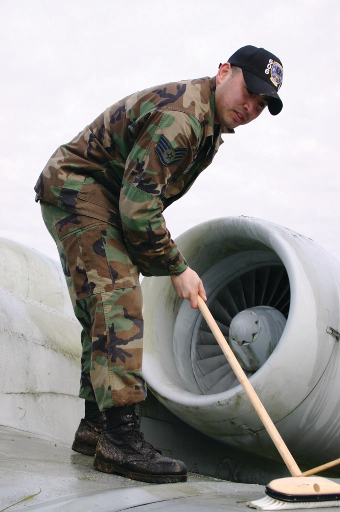 SPANGDAHLEM AIR BASE, GERMANY -- Staff Sgt. Gianpierre Salazar, 606th Air Control Squadron,  scrubs the wing of the A-10 on display at the Spangdahlem Air Base Air Park.  (Photo by Staff Sgt. Daniel Heise) 