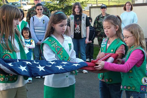 SPANGDAHLEM AIR BASE, GERMANY -- Left to Right, Mikayla DeMers, Alexis Quinones, Kaitlin King and Amber Couturier fold the Spangdahlem Middle School flag. Alexis, Kaitlin and Amber are all members of Junior Troop 198. Mikayla is a member of Junior Troop 702. This year the Girl Scouts have held a crime scene investigation workshop, celebrated World Thinking Day, were involved with Operation Open Arms and more. For more information about base Girl Scout Troops, e-mail spangdahlemgirlscouts@hotmail.com. (Photo by Kimberly Shock)
