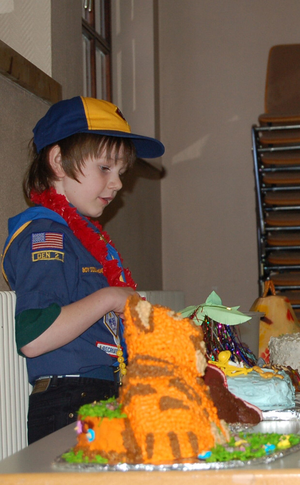 SPANGDAHLEM AIR BASE, GERMANY -- Nathaniel Hathaway, son of Tech. Sgt. Kathlene Hathaway, 52nd Logistics Readiness Squadron, looks at the cakes on display for purchase during the Boy Scouts of America Annual Awards Banquet. Nathaniel is a Wolf Scout. (US Air Force photo/Staff Sgt. Tammie Moore)