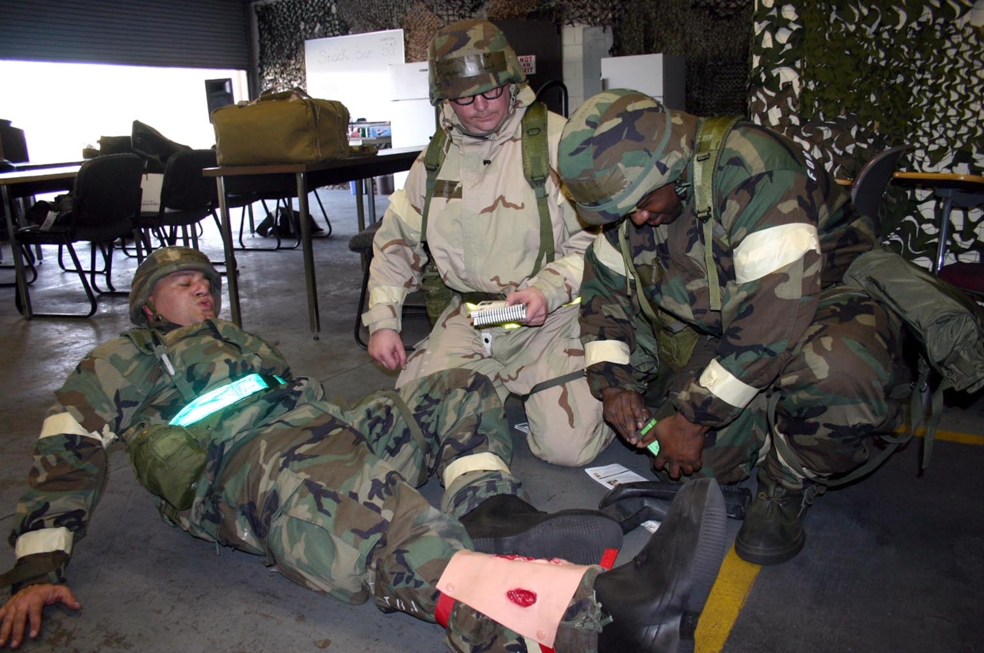 Members of the 21st Air Mobility Operations Squadron simulate tending to a battle wound while being tested on their ability to survive and operate skills Wednesday. The Air Mobility Command Inspector General team was testing the 21st AMOS on ATSO skills as part of the 621st Contingency Response Wing’s Operational Readiness Inspection. This is the first ORI for the 621st CRW. 