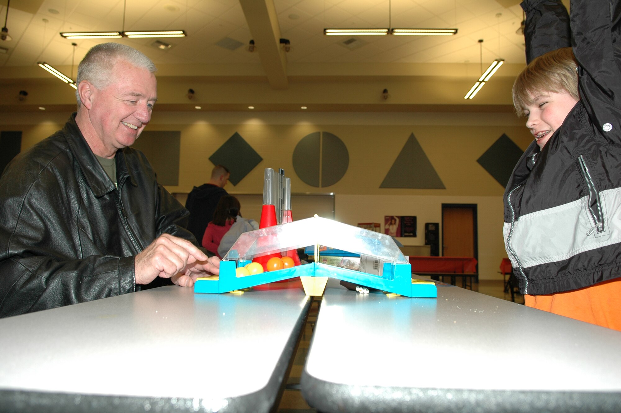 FAIRCHILD AIR FORCE BASE, Wash. -- Alex Edwards, son of Jodi, PTO treasurer, and Staff Sgt. Bradley Edwards, 92nd SFS, beats Del Walters, Alex’s grandfather at a game during game night at Michael Anderson Elementary School here March 15. The school’s PTO hosted the game night to help promote family time and interaction. (U.S. Air Force photo/Staff Sgt. Kristian Carter)