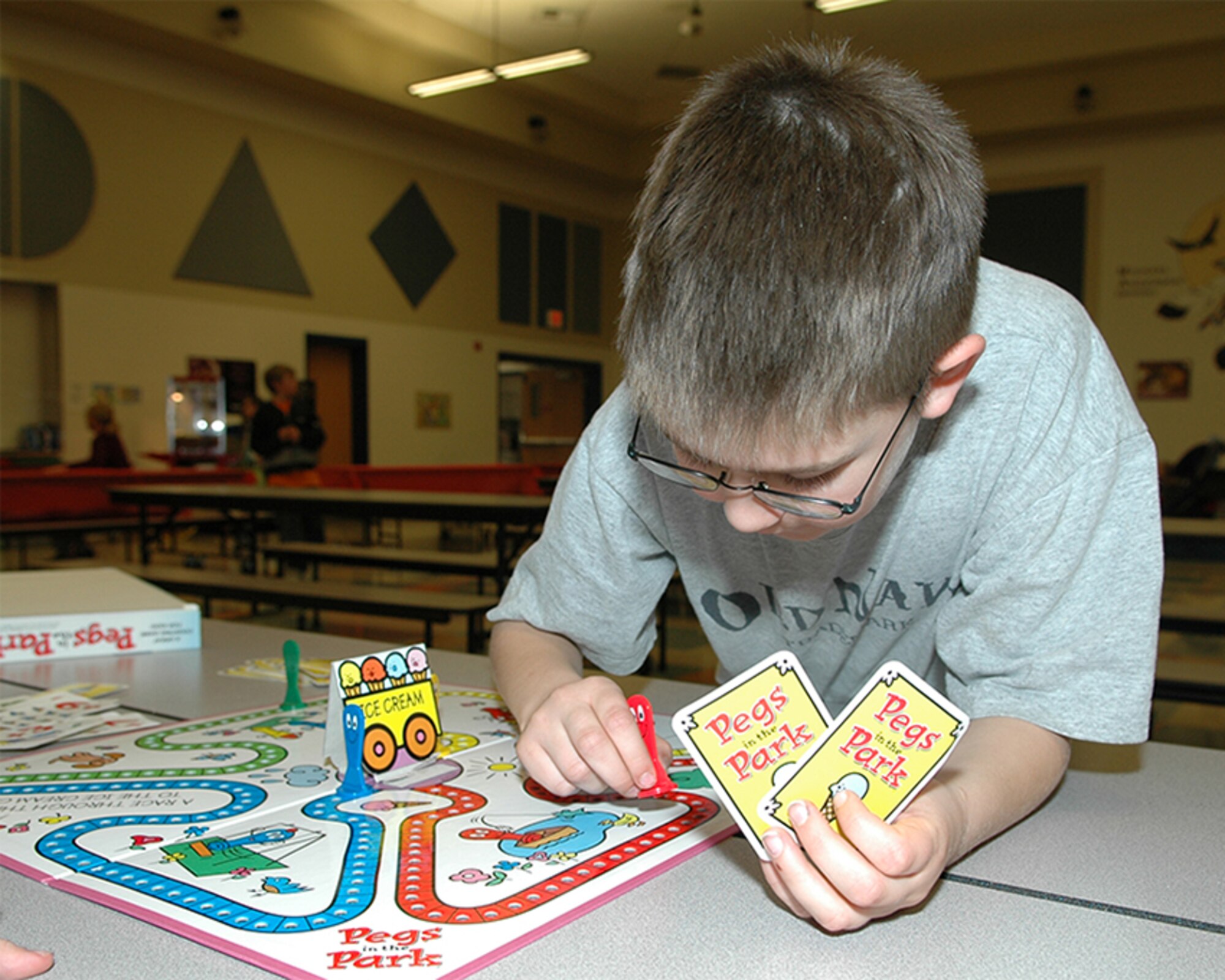 FAIRCHILD AIR FORCE BASE, Wash. – Michael Robinson, son of Amanda and Navy Petty Officer 1st Class Chadd Robinson, makes a move while playing a board game with another child at game night at Michael Anderson Elementary School here March 15. (U.S. Air Force photo/Staff Sgt. Kristian Carter)