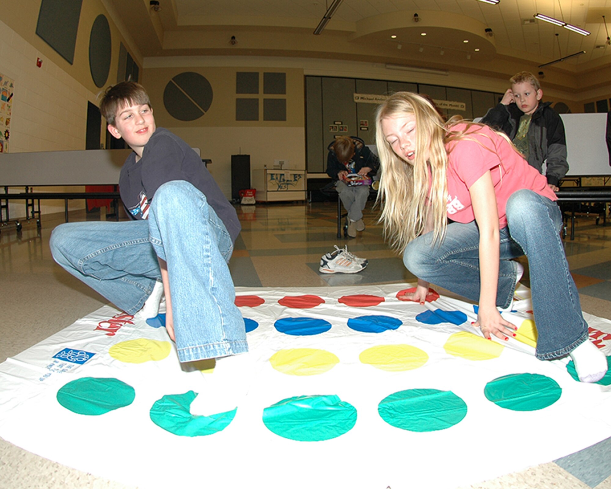 FAIRCHILD AIR FORCE BASE, Wash. – Robert Robinson, son of Amanda, Parent Teacher Organization president, and Navy Petty Officer 1st Class Chadd Robinson, tests his balance next to Kelli Walters, daughter of Jodi, PTO treasurer, and Staff Sgt. Bradley Edwards, 92nd Security Forces Squadron, during a game of skill at game night at Michael Anderson Elementary School here March 15. The school’s PTO hosted the game night to help promote family time and interaction. (U.S. Air Force photo/Staff Sgt. Kristian Carter)