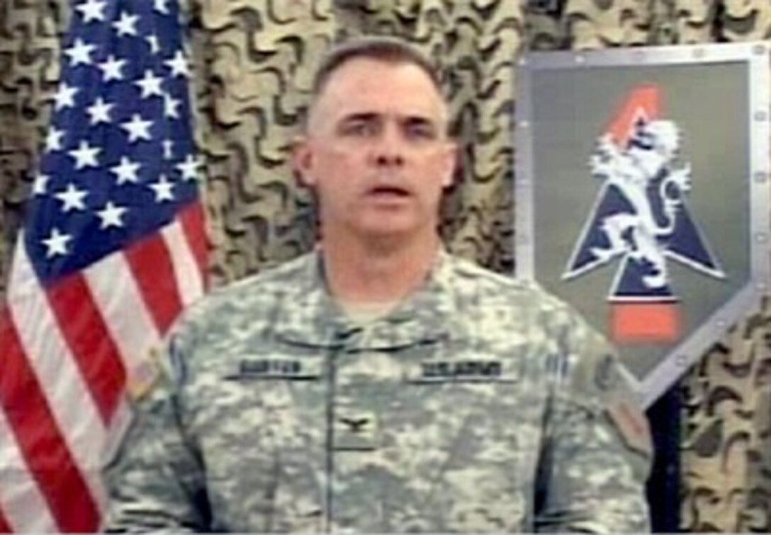 U.S. Army Col. J.B. Burton, commander of the 2nd Brigade Combat Team, 1st Infantry Division, speaks with Pentagon reporters via satellite, March 16, 2007, providing an update on ongoing security operations in Iraq.