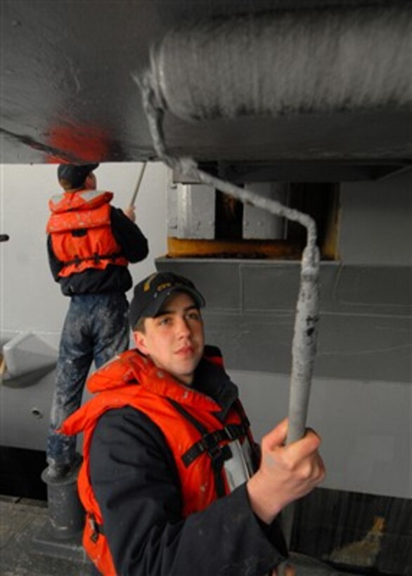 U.S. Navy Seaman Harold G. Lanham applies haze-gray paint to an aircraft elevator on the aircraft carrier USS Abraham Lincoln (CVN-72) at Naval Base Kitsap Bremerton, Wash., on March 14, 2007.  Lincoln is wrapping up the last phase of its dry-dock planned incremental availability which prepared the ship for its return to full operational capability.  