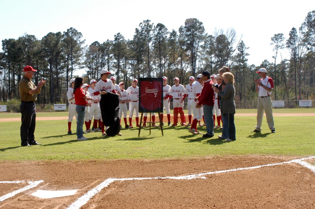 SUMMERFIELD, La. - Lance Cpl Jon Eric Bowman's jersey is presented at the retirement ceremony of the fallen Marine's high school baseball jersey. Summerfield High School retired the jersey in recognition of Bowman's heroic contribution to the Marine Corps and their town.