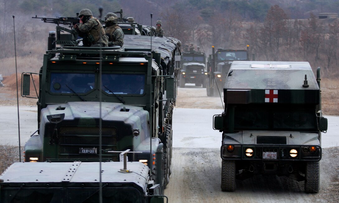 RODRIGUEZ LIVE FIRE COMPLEX, Republic of Korea ? Marines and sailors from Combat Logistics Battalion 31, the combat service support element of the 31st Marine Expeditionary Unit, provide cover for a medical vehicle during a convoy live-fire training event here, March 17. The CLB conducted the training to become proficient in neutralizing those who would sabotage vehicles on the road. The CLB is the combat service support element of the 31st Marine Expeditionary Unit.