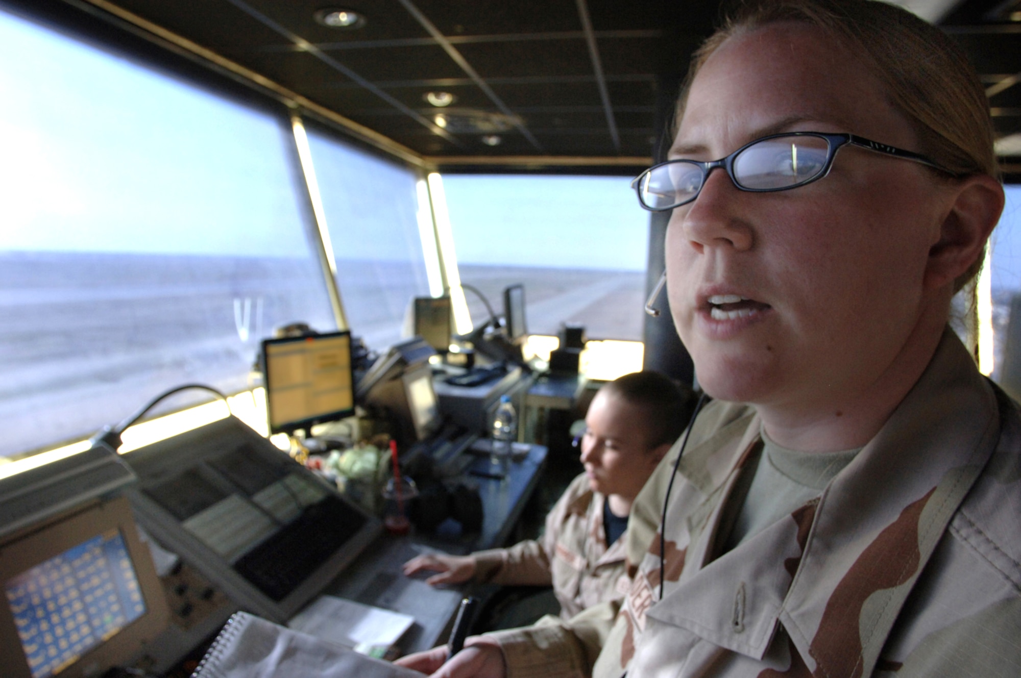 BALAD AIR BASE, Iraq -  Senior Airmen Sara Mader and Kristen Bundrick, 332nd Expeditionary Operational Support Squadron, Air Traffic Controllers comunicate with aircraft to ensure safe landings and takeoffs from the Balad tower Mar. 10, 2007. (U.S. Air Force photo/Staff Sgt. Michael R. Holzworth)