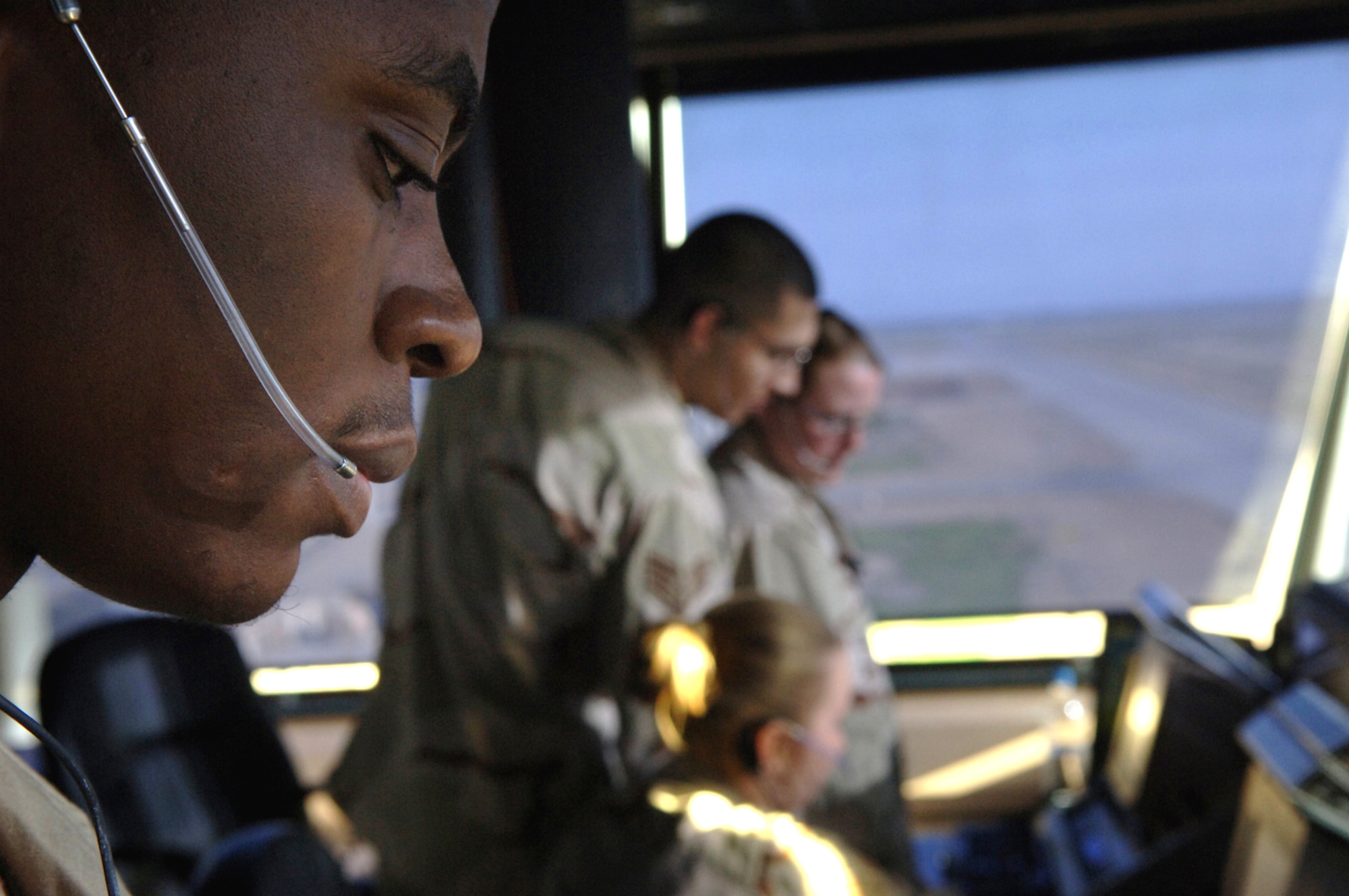 BALAD AIR BASE, Iraq - Staff Sgt. Jerome Cole, Senior Airmen Sara Mader, Kristen Bundrick, and Staff Sgt. John Topete, 332nd Expeditionary Operational Support Squadron, Air Traffic Controllers comunicate with aircraft to ensure safe landings and takeoffs from the Balad tower Mar. 10, 2007. (U.S. Air Force photo/Staff Sgt. Michael R. Holzworth)