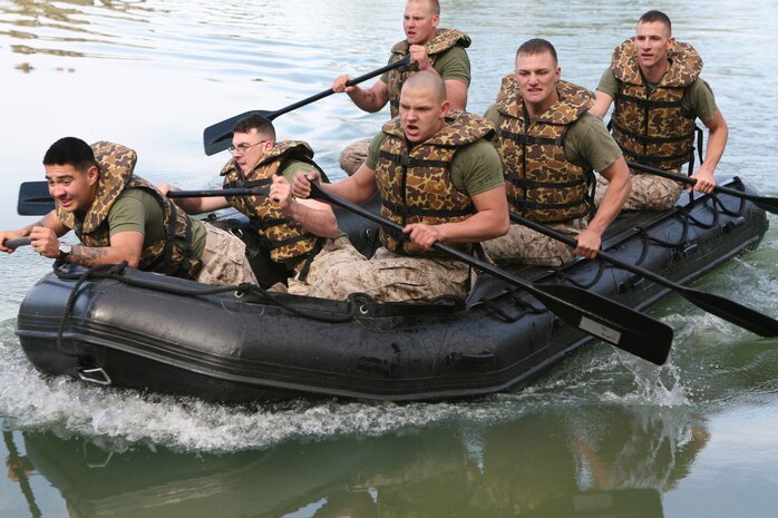 Marines row a Zodiac Inflatable Raft during the St. Patrick?s Day Field Meet, here, March 18. The field meet was a way for the Marines and sailors of 8th ESB to celebrate the life of St. Patrick, who is the patron saint of engineers. The Zodiac boat race was an event where Marines raced on foot while carrying the rafts and then continued racing through a small pond.