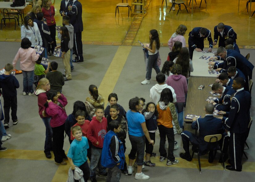 The United States Air Force Honor Guard Drill Team speaks to children at Clovis Community College, Clovis, N.M., March 12, 2007. The Drill Team is the traveling component of the Air Force Honor Guard and tours Air Force bases world wide showcasing the precision of today's Air Force to recruit, retain, and inspire Airmen for the Air Force mission. (U.S. Air Force photo by Airman 1st Class Rusti Caraker)(Released)