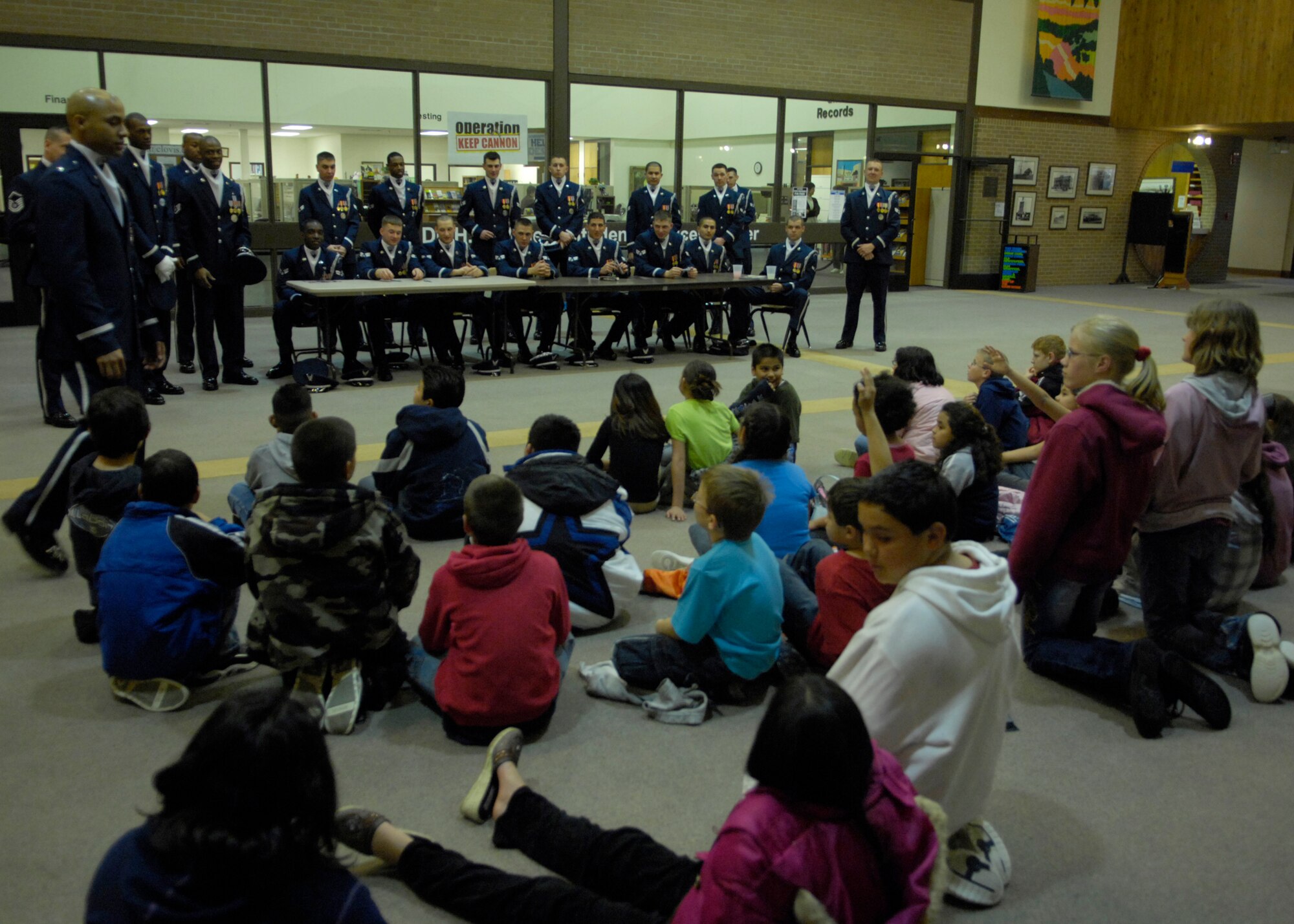 The United States Air Force Honor Guard Drill Team speaks to children at Clovis Community College, Clovis, N.M., March 12, 2007. The Drill Team is the traveling component of the Air Force Honor Guard and tours Air Force bases world wide showcasing the precision of today's Air Force to recruit, retain, and inspire Airmen for the Air Force mission. (U.S. Air Force photo by Airman 1st Class Rusti Caraker)(Released)
