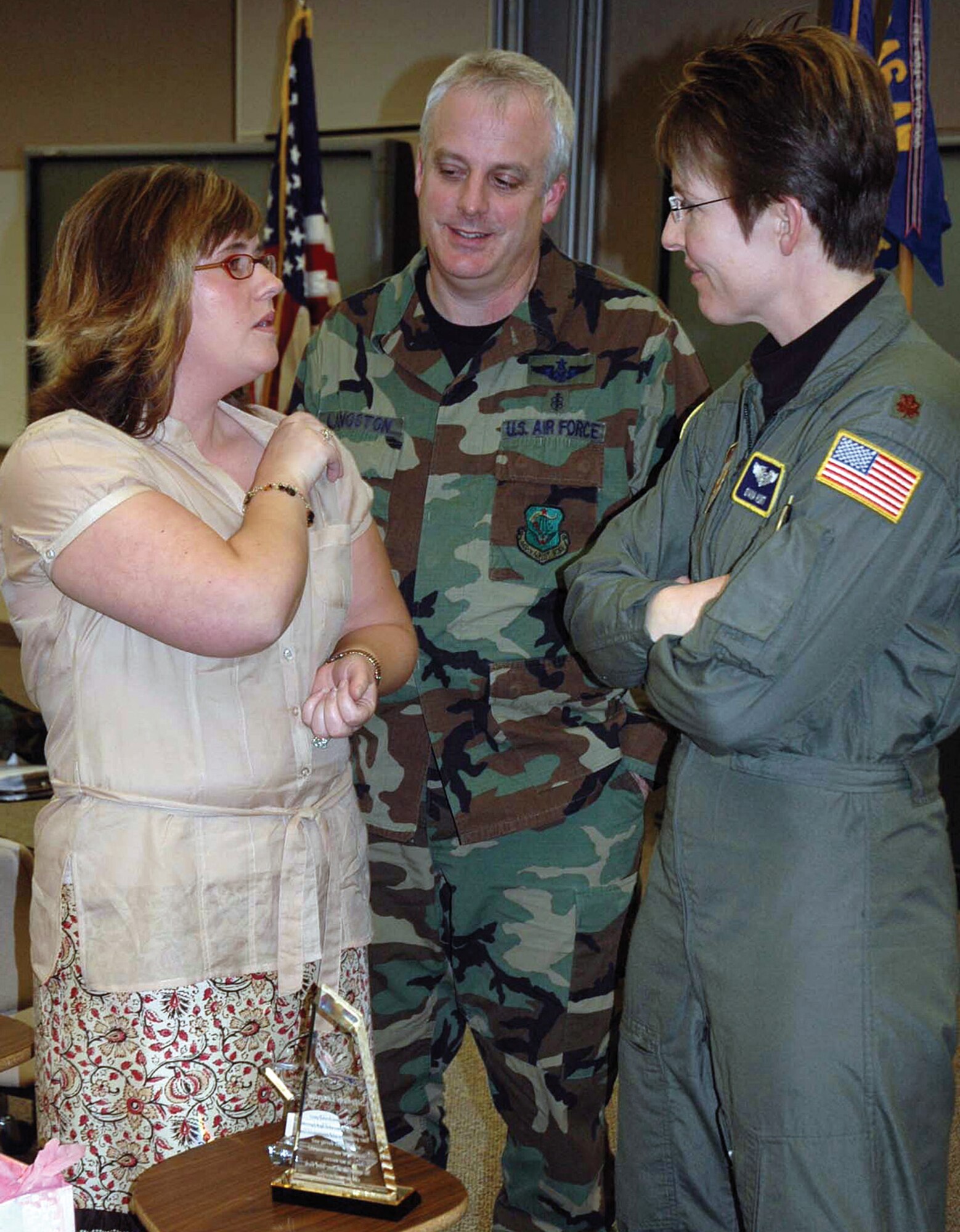 MCCHORD AIR FORCE BASE, Wash. - Stephany Langston, left, is congratulated by her husband Tech. Sgt. Clay Langston and a fellow 446th Aeromedical Staging Squadron Airman, on her key spouse award. (U.S. Air Force photo by Staff Sgt. Paul Haley)