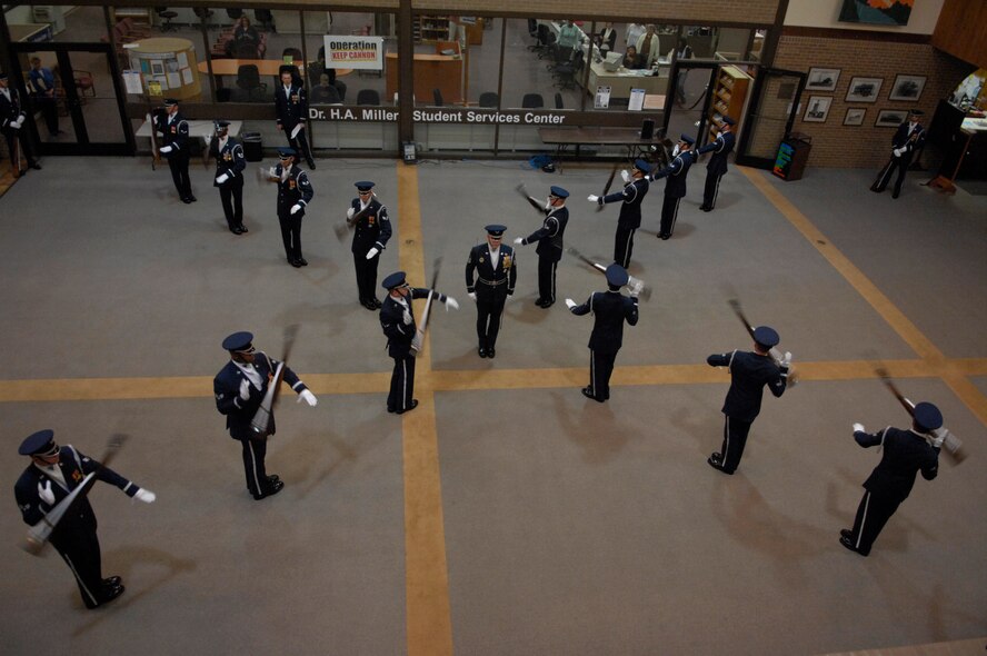 The United States Air Force Honor Guard Drill Team performs at Clovis Community College, Clovis, N.M., March 12, 2007. The Drill Team is the traveling component of the Air Force Honor Guard and tours Air Force bases world wide showcasing the precision of today's Air Force to recruit, retain, and inspire Airmen for the Air Force mission. (U.S. Air Force photo by Airman 1st Class Rusti Caraker)(Released)