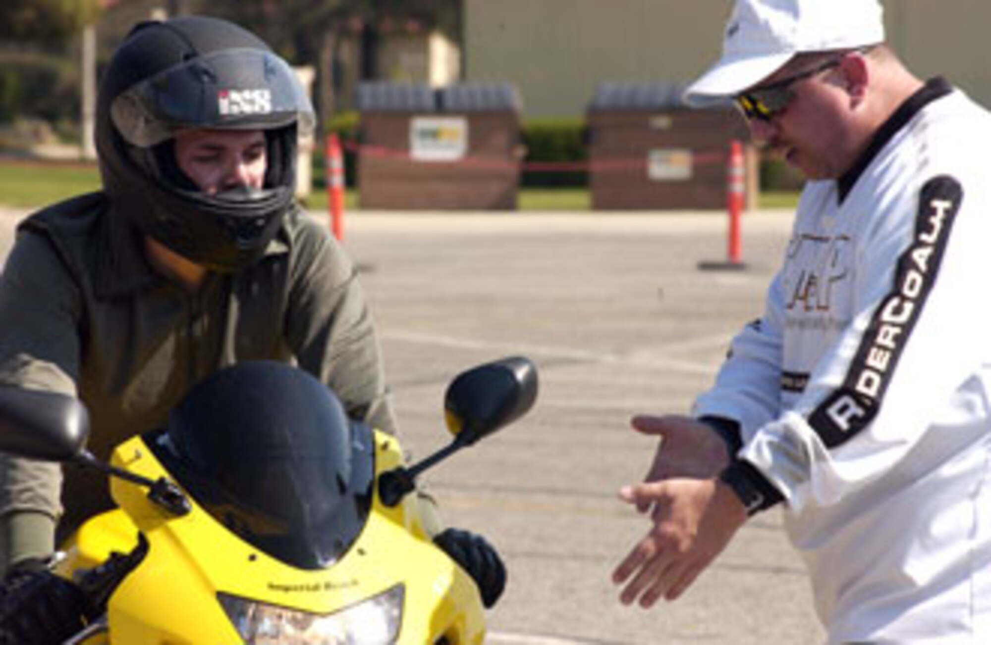 Instructor Gene Reeks gives Senior Airman Jaime Hinojosa-Guzman,
452nd LRS, some tips while riding the beginning motorcycle rider's course at March Air Reserve Base.  (U.S. Air Force photo by Staff Sgt. Amy Abbott)