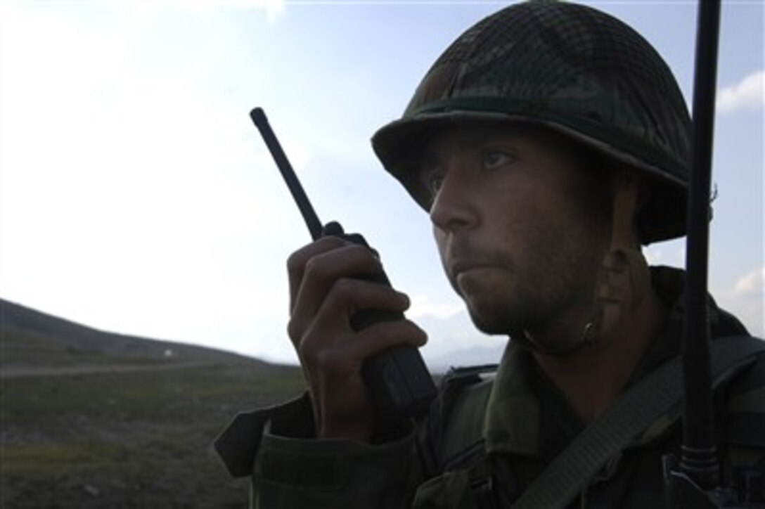 An Afghan National Army officer candidate communicates with air support to evacuate a simulated patient onto an Italian UH-60 Huey Helicopter during a medical evacuation exercise held at the Kabul Military Training Center, March 15, 2007. 
