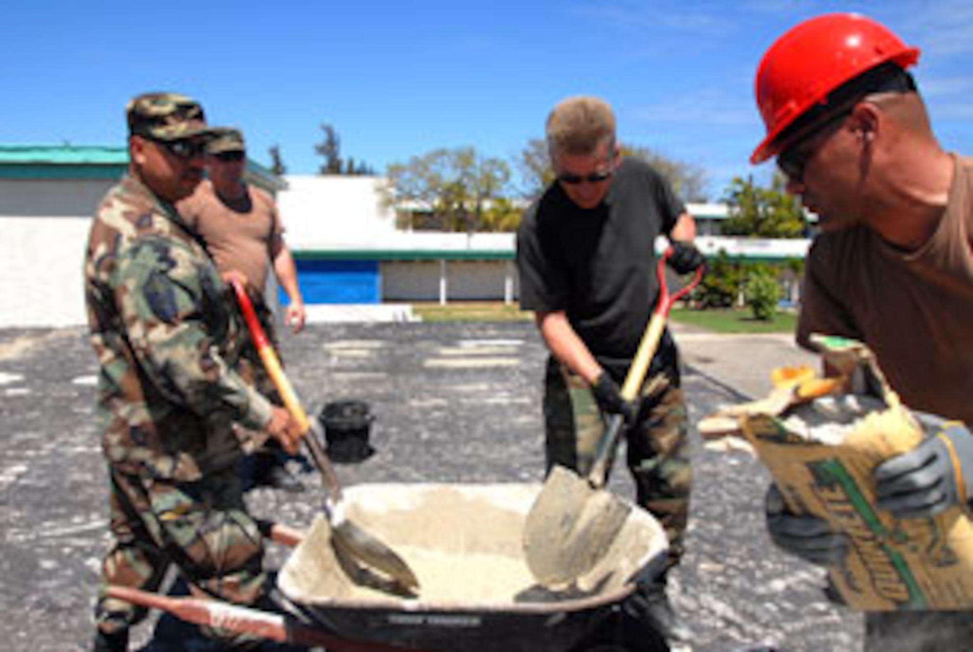 California Air National Guard members Master Sgt. Moses Alvarado (left to right), Tech. Sgt. Greg Jackson, Tech. Sgt. Paul Gomez and Stacy Burnside, all from the 163d RW, March Air Reserve Base, Calif., mix cement in the plaza during a building renovation on Coast Guard Air Station Borinquen, Puerto Rico. (U.S. Air Force photos by Senior Airman Diane Ducat/163d RW)