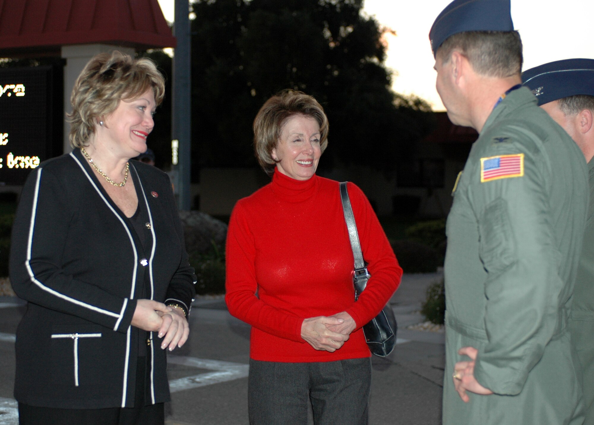 Nancy Pelosi, (D-Calif.), Speaker of the House, and Representative Ellen Tauscher, (D-Calif.), speak with Col. Steve Arquiette, 60th Air Mobility Wing commander, shortly after their arrival March 15.  This was the first stop for Madame Speaker Pelosi and Mrs. Tauscher during their trip to California. (U.S. Air Force photo by Airman Kristen Rohrer)