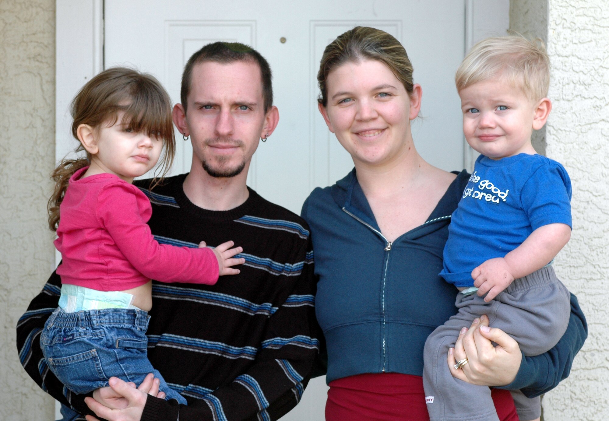 Senior Airman Jacqueline Ruhf, 60th Medical Operations Squadron medical technician, poses with her husband and two children. When a out-of-state family emergency occurred, Airman Ruhf searched for airline tickets, but could not find tickets for less than $1,200 each. With help from the Air Force Assistance Fund, Airman Ruhf was able to find and purchase airline tickets at a lower price. (U.S. Air Force photo by Staff Sgt. Candy Knight)