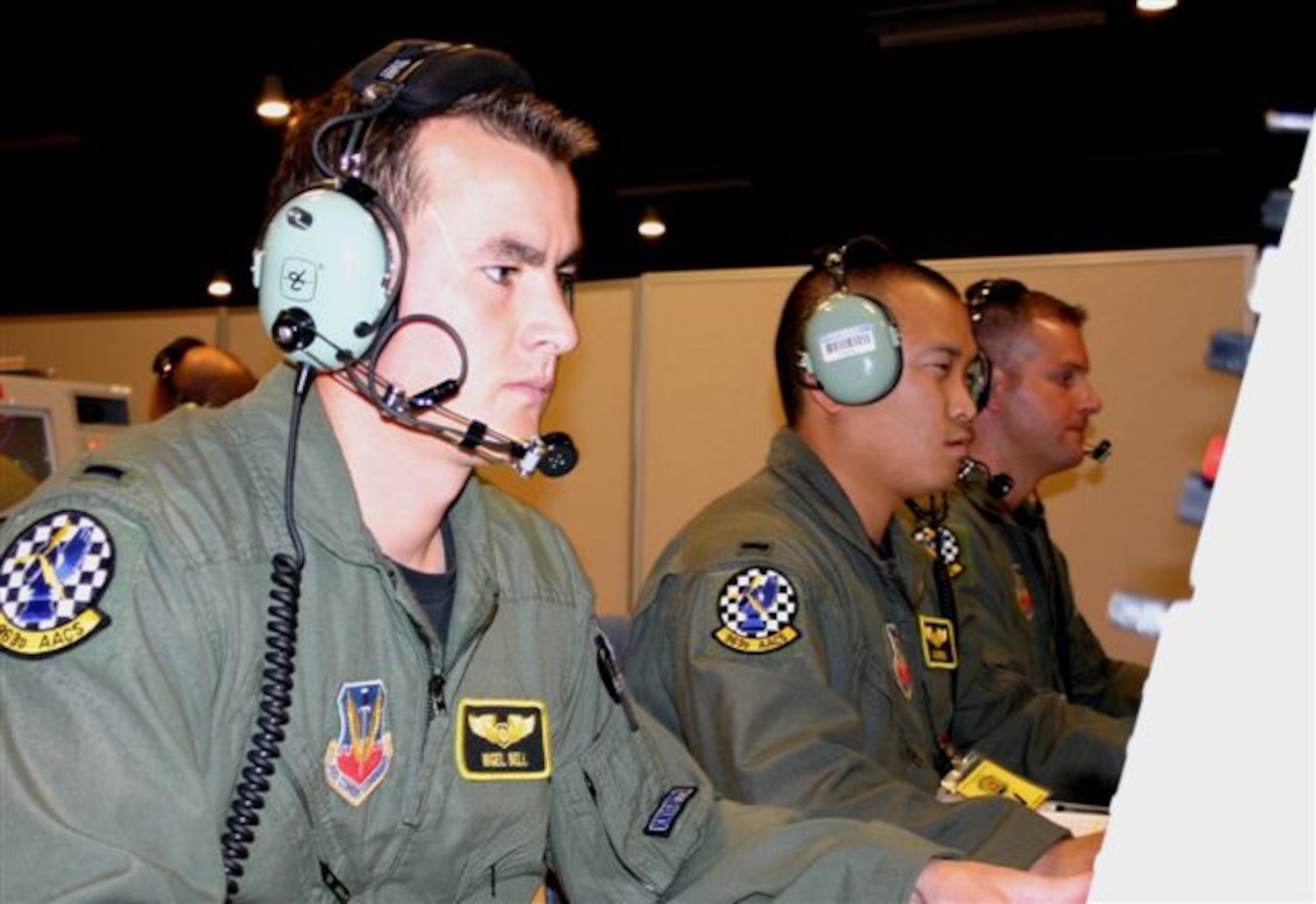 1st Lts. Nigel Bell and Jerrad Brown, both from the 963rd Airborne Air Control Squadron, work to control the aerial battlespace during exercise Virtual Flag 06 at the Distributed Mission Operations Center here.  (U.S. Air Force photo)
