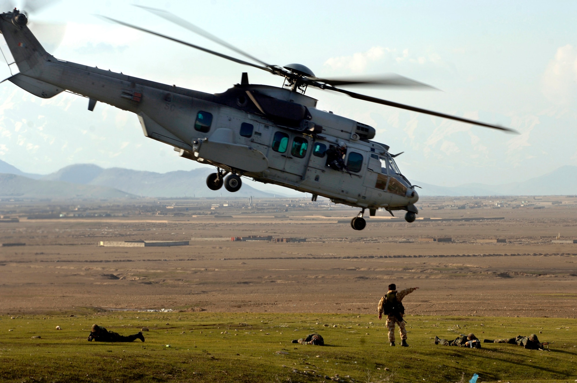 An International Security Assistance Force member signals a French Cougar helicopter at a landing zone March 15 during a medical evacuation exercise being held at the Kabul Military Training Center in Afghanistan. ISAF and DOD members help train ANA officer candidates on practical scenarios such as IED attacks, self-aid and buddy care and patient evacuation.  (U.S. Air Force photo/Tech. Sgt. Cecilio M. Ricardo Jr.) 