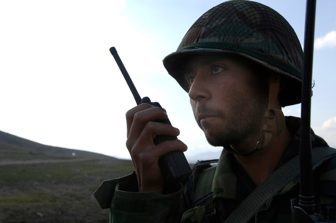An Afghan National Army officer candidate calls for air support to evacuate a "patient" March 15 during a medical evacuation exercise being held at the Kabul Military Training Center in Afghanistan.  U.S. Air Force members provide military guidance and mentorship for the ANA instructors, officers and trainees at KMTC. (U.S. Air Force photo/Tech. Sgt. Cecilio M. Ricardo Jr.) 