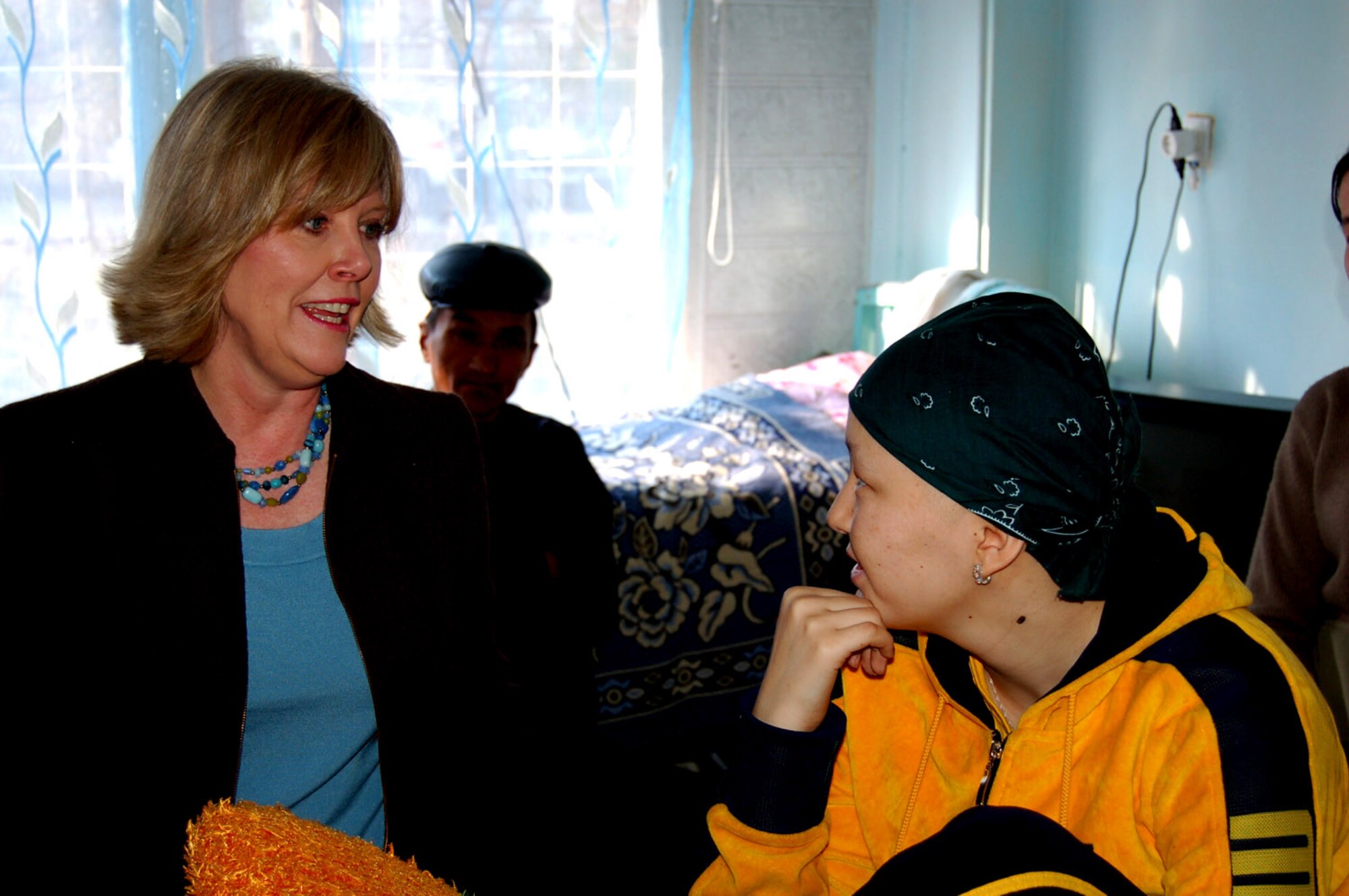 Suzie Schwartz, wife of Gen. Norton Schwartz, U.S. Transportation Command commander, spends time with a patient at the Children's Cancer Center March 14 in Kyrgystan. She took part in the Manas Air Base Outreach Society trip while General Schwartz was here for high-level discussions on regional security and promoting further cooperation between the United States and the Kyrgyz Republic to help bring peace and prosperity to Afghanistan. (U.S. Air Force photo/Senior Master Sgt. Timothy Cook)