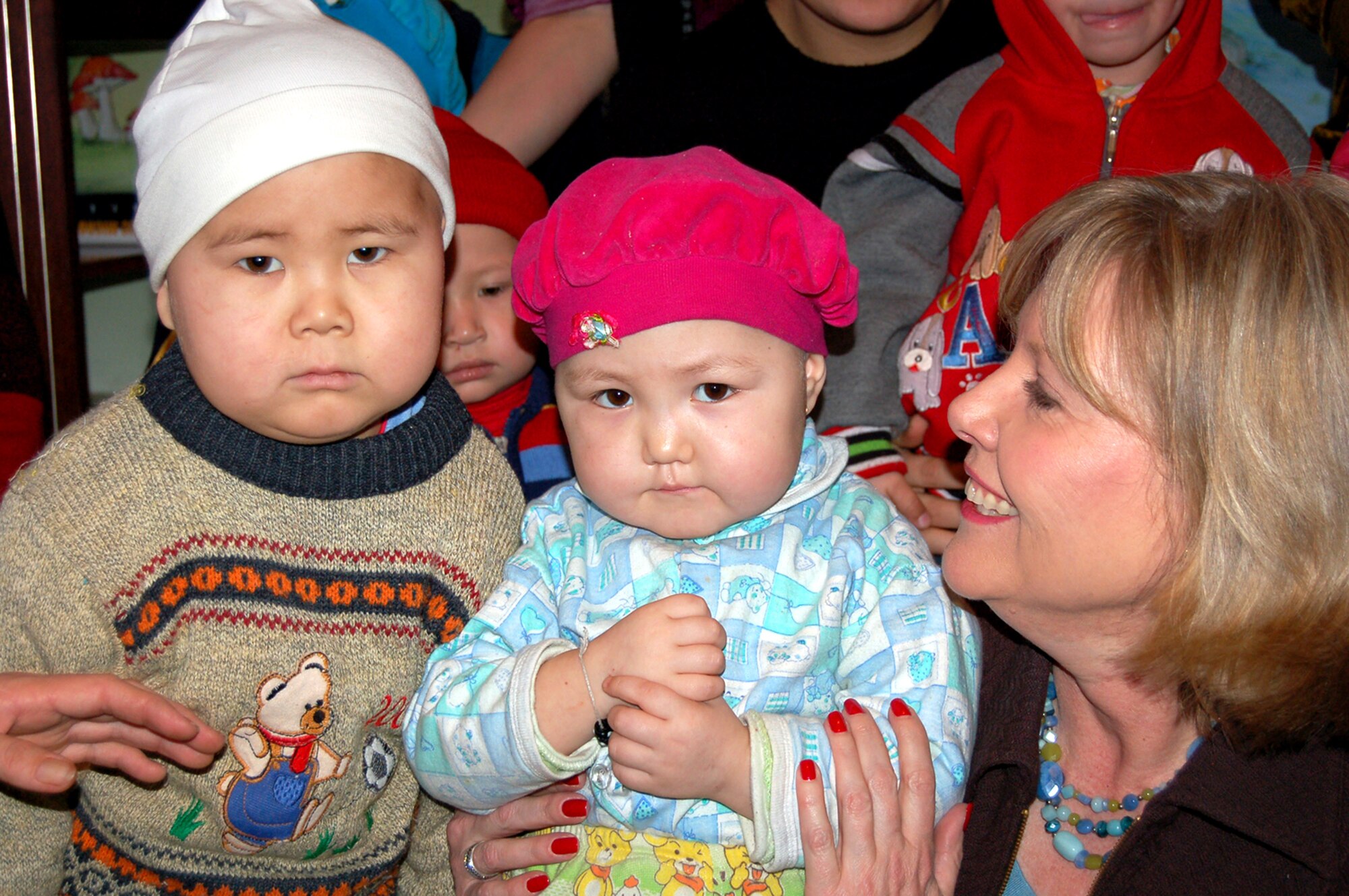 Suzie Schwartz, wife of Gen. Norton Schwartz, U.S. Transportation Command commander, spends time with patients from the Children's Cancer Center March 14 in Kyrgystan. She took part in the Manas Air Base Outreach Society trip while General Schwartz was here for high-level discussions on regional security and promoting further cooperation between the United States and the Kyrgyz Republic to help bring peace and prosperity to Afghanistan. (U.S. Air Force photo/Senior Master Sgt. Timothy Cook)