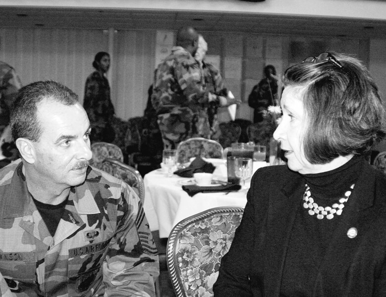 Chief Master Sgt. Herb Hanson, 43rd Airlift Wing command chief, talks with North Carolina Representative Margaret Highsmith Dickson at the Women's History Luncheon Tuesday at the Pope Club. The representative was the guest speaker for the luncheon.