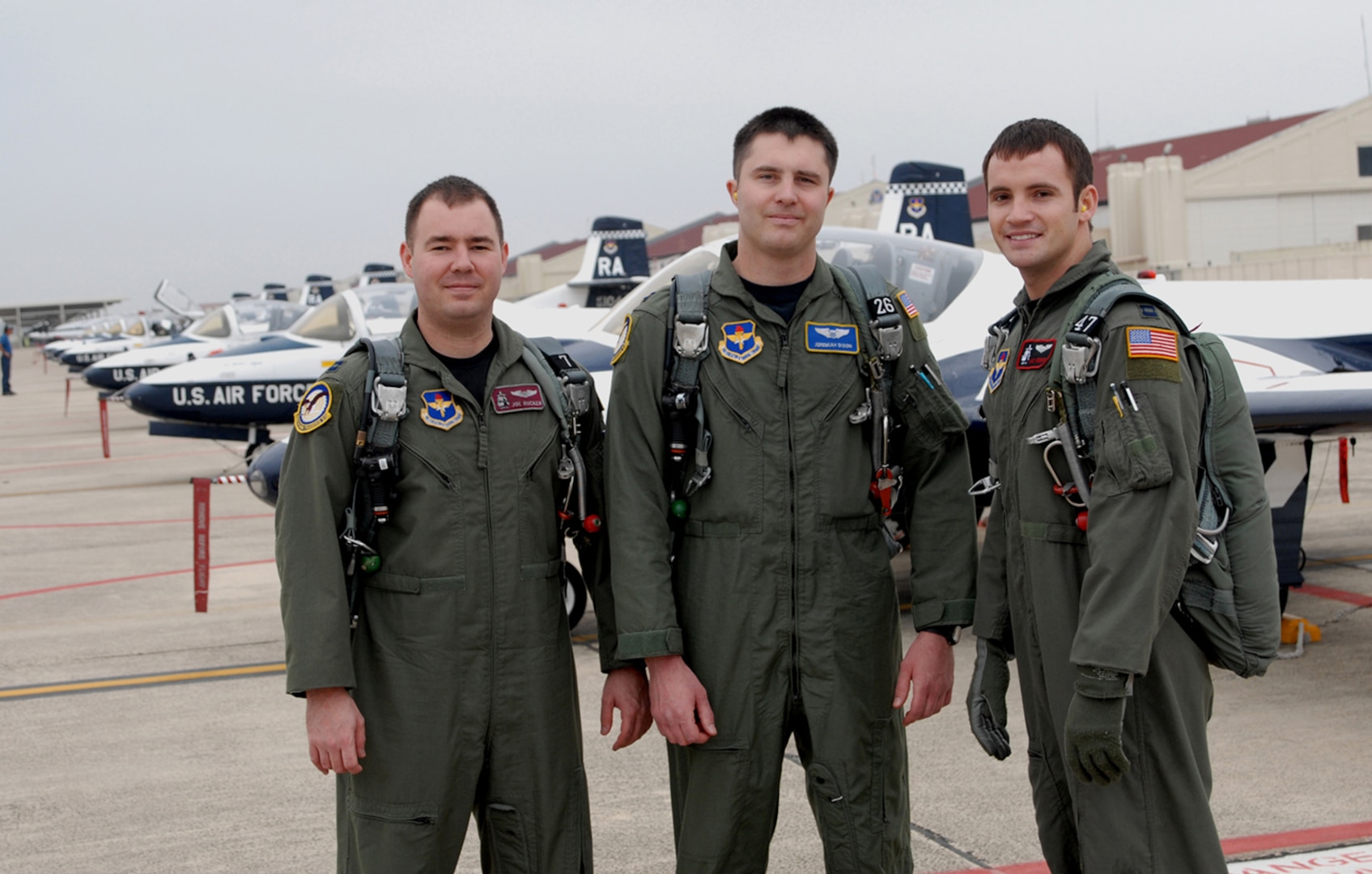 Capts. Joe Rucker (from left to right). Jeremiah Dixon and Lacy Gunnoe, 559th Flying Training Squadron T-37 instructor pilot students, stand before the remaining Randolph T-37 fleet on the west flightline. The students are the last class of IPs to undergo training on the T-37. (U.S. Air Force photo by Melissa Peterson)