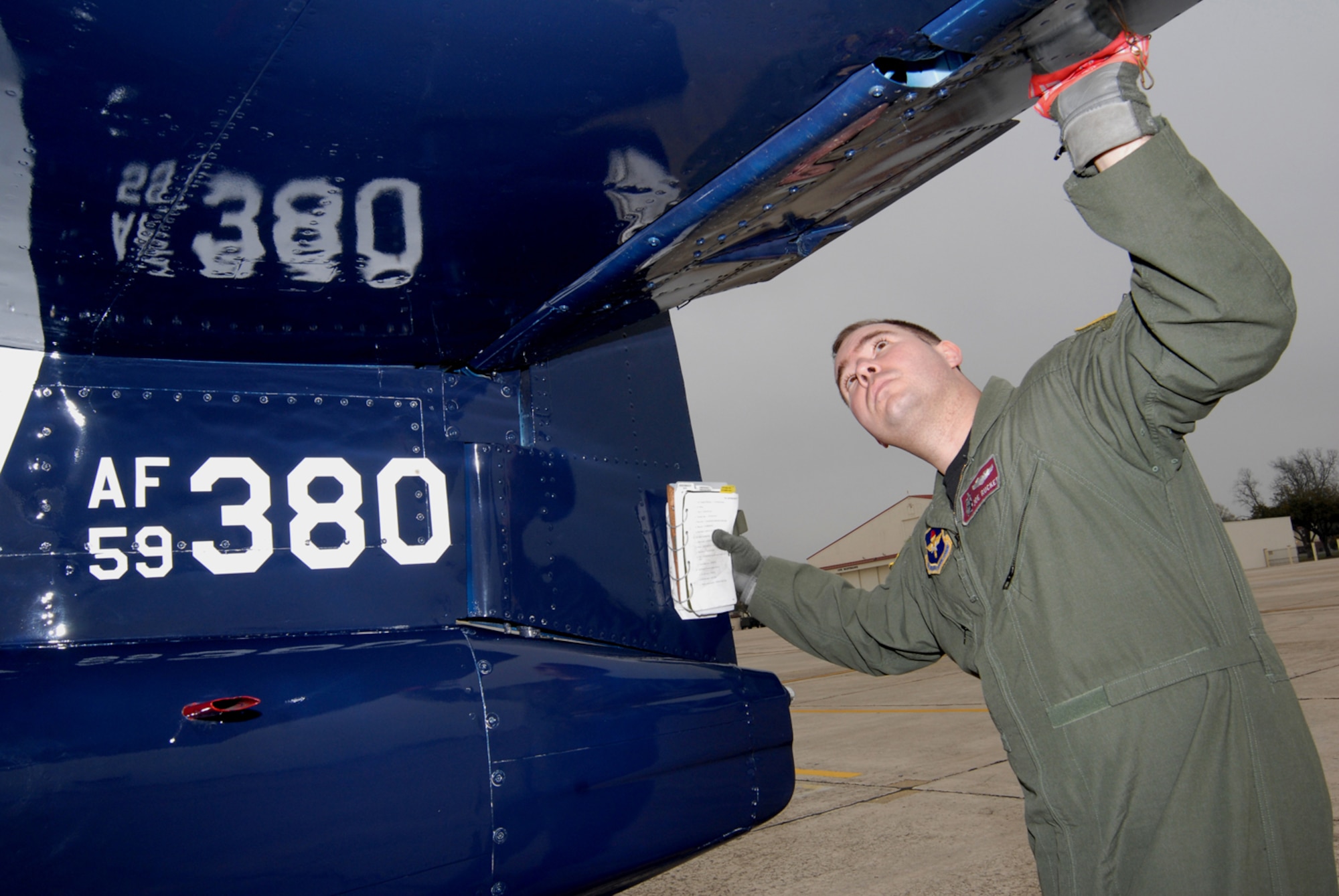 Capt. Joe Rucker, 559th Flying Training Squadron T-37 instructor pilot student, checks the aircraft's elevator during an exterior inspection check. (U.S. Air Force photo by Melissa Peterson)