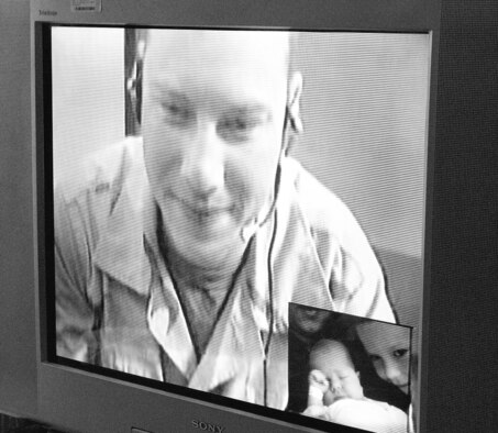 Staff Sgt. Jack Pate sees his newborn son, Hunter, for the first time with the help of virtual teleconferencing technology. The VTC was set up by the non-profit group Freedom Calls. Sergeant Pate was also able to talk to his son Tyler, his wife and mother during the hour-long visit.