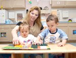 Kelly Stokes, Randolph Child Development Program assistant, supervises as Kaitlyn Rodriguez (left) and Michael Chase explore the texture board at the child development center annex March 14. (U.S. Air Force photo by Melissa Peterson)