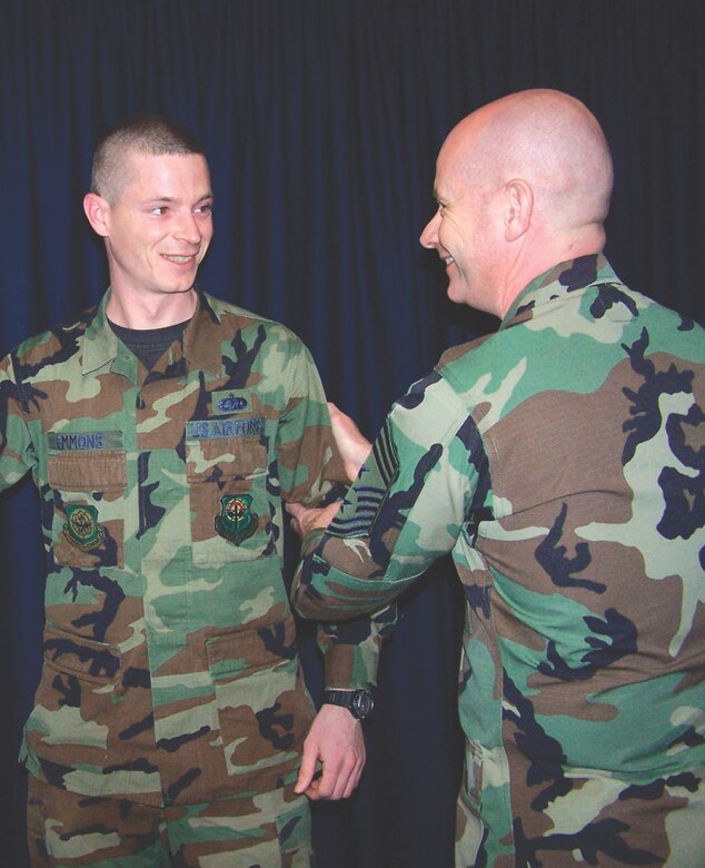 MCCHORD AIR FORCE BASE, Wash. -- Chief Master Sgt. Russell Kuck, 62nd Airlift Wing command chief master sergeant, right, tacks on step-promotee Tech. Sgt. John Emmons, 62nd Aircraft Maintenance Squadron, March 13, 2006 at the Blue Aircraft Maintenance Unit's roll call.(U.S. Air Force Photo/Staff Sgt. Zed Nelson)

