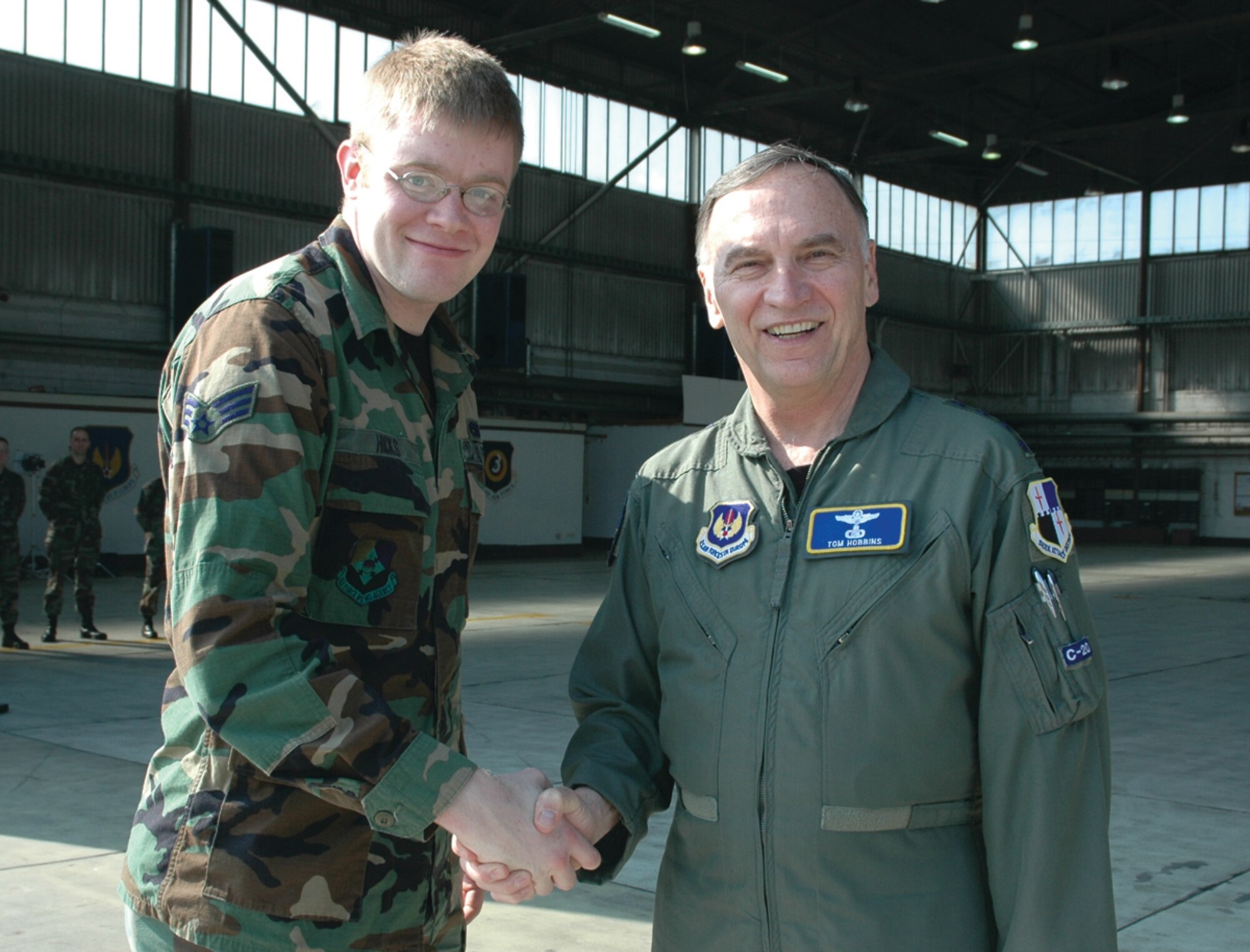 SPANGDAHLEM AIR BASE, Germany -- Gen. Tom Hobbins, U.S. Air Forces in Europe commander, meets Senior Airman Daivd Hicks, American Forces Network, Detachment 9, while at Spangdahlem Air Base to shoot an American Forces Network commercial here March 15.