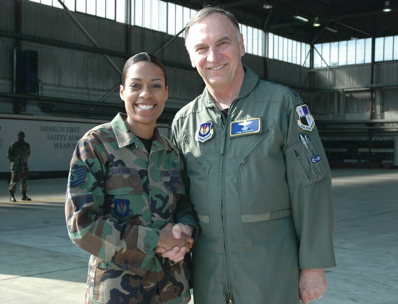 SPANGDAHLEM AIR BASE, Germany -- Gen. Tom Hobbins, U.S. Air Forces in Europe commander, coins Tech. Sgt. Khalisha Savage, 52nd Fighter Wing, while at Spangdahlem Air Base to shoot an American Forces Network commercial here March 15.  