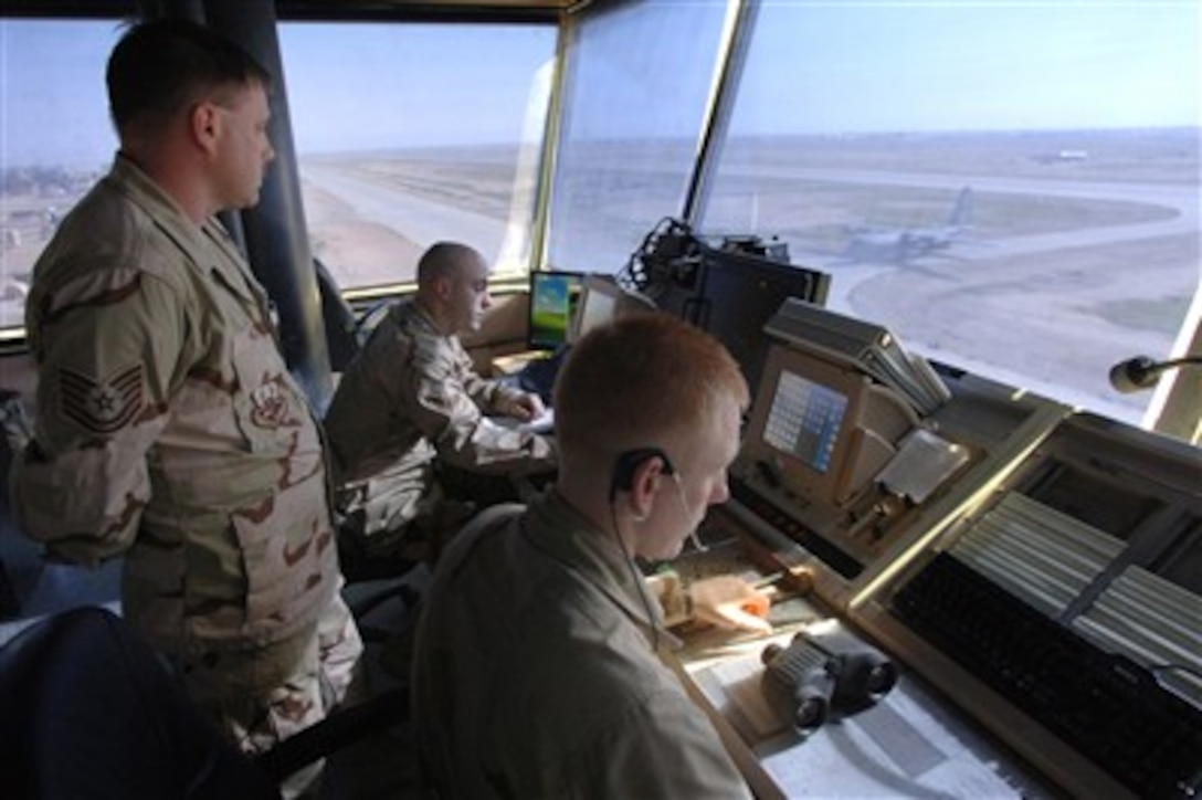 U.S. Air Force Tech. Sgt. John McCoy (left) and Senior Airman Beau Portman (right) air traffic controllers with the 332nd Expeditionary Operational Support Squadron communicate with aircraft from the Balad tower at Balad Air Base, Iraq, to ensure safe landings and takeoffs on March 14, 2007.  