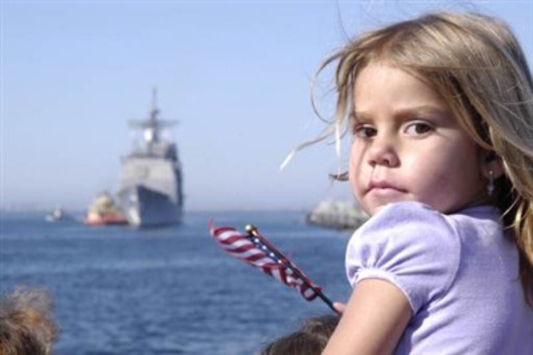 A young girl awaits the arrival of the guided-missile cruiser USS Bunker Hill during a homecoming ceremony March 13, 2007, in San Diego, Calif.  Bunker Hill returned from a regularly scheduled six-month deployment as part of Boxer Expeditionary Strike Group