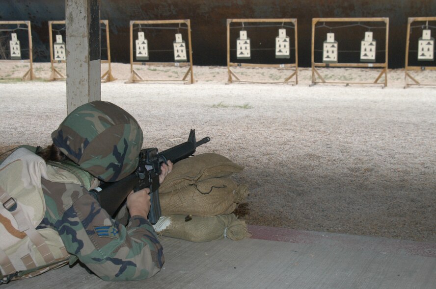 Senior Airman Nicole Palermo, 7th Services Squadron, practices for M-16 qualification with her necessary flak gear and Kevlar helmet at the firing range here March 20 before her upcoming deployment. (U.S. Air Force photo by Airman 1st Class Carolyn Viss)
