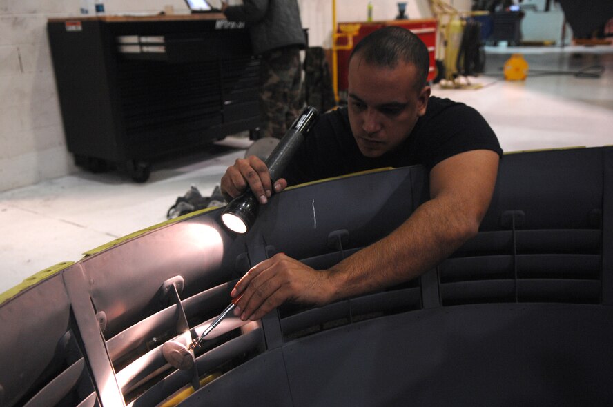 MINOT AIR FORCE BASE, N.D., --Staff Sergeant Luis Santiago, 5th Maintenance Squadron, searches for damage with a flashlight and mirror on a nacelle cowling used on a B-52 Stratofortress. The 5th Maintenance Group is one of the four 5th Bomb Wing groups responsible for the 5th BW's selection as Air Combat Command's 2006 Verne Orr Award nominee. This award is presented annually by the Air Force Association and recognizes an Air Force unit for best use of human resources.  (U.S. Air Force photo by Airman 1st Class Christopher Boitz)  