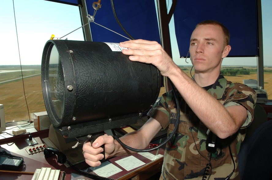 MINOT AIR FORCE BASE, N.D. -- Airman 1st Class Joshua Kelley, 5th Operations Support Squadron, air traffic controller, checks signaling equipment at the Minot Air Force Base air traffic control tower. The 5th Operations Support Group is one of the four 5th Bomb Wing groups responsible for the 5th BW's selection as Air Combat Command's 2006 Verne Orr Award nominee. This award is presented annually by the Air Force Association and recognizes an Air Force unit for best use of human resources. (U.S. Air Force photo by Senior Airman Christopher Boitz)