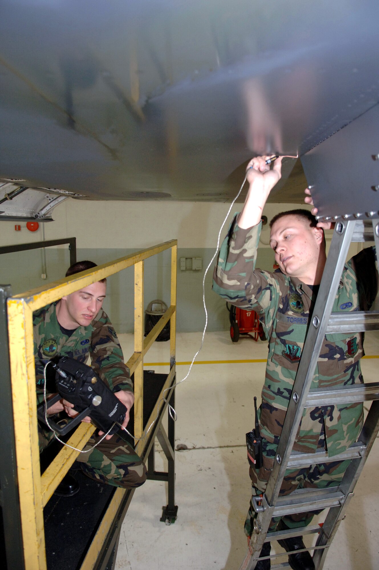 Airman 1st Class Ehud Torres and A1C Trevor Knapp inspect for possible cracks with the Nortec 2000D on the B-1B Lancer March 19 at Ellsworth Air Force Base, S.D. The Airmen are nondestructive inspections technicians with the 28th Maintenance Squadron. (U.S. Air Force photo/Airman 1st Class Angela Ruiz)