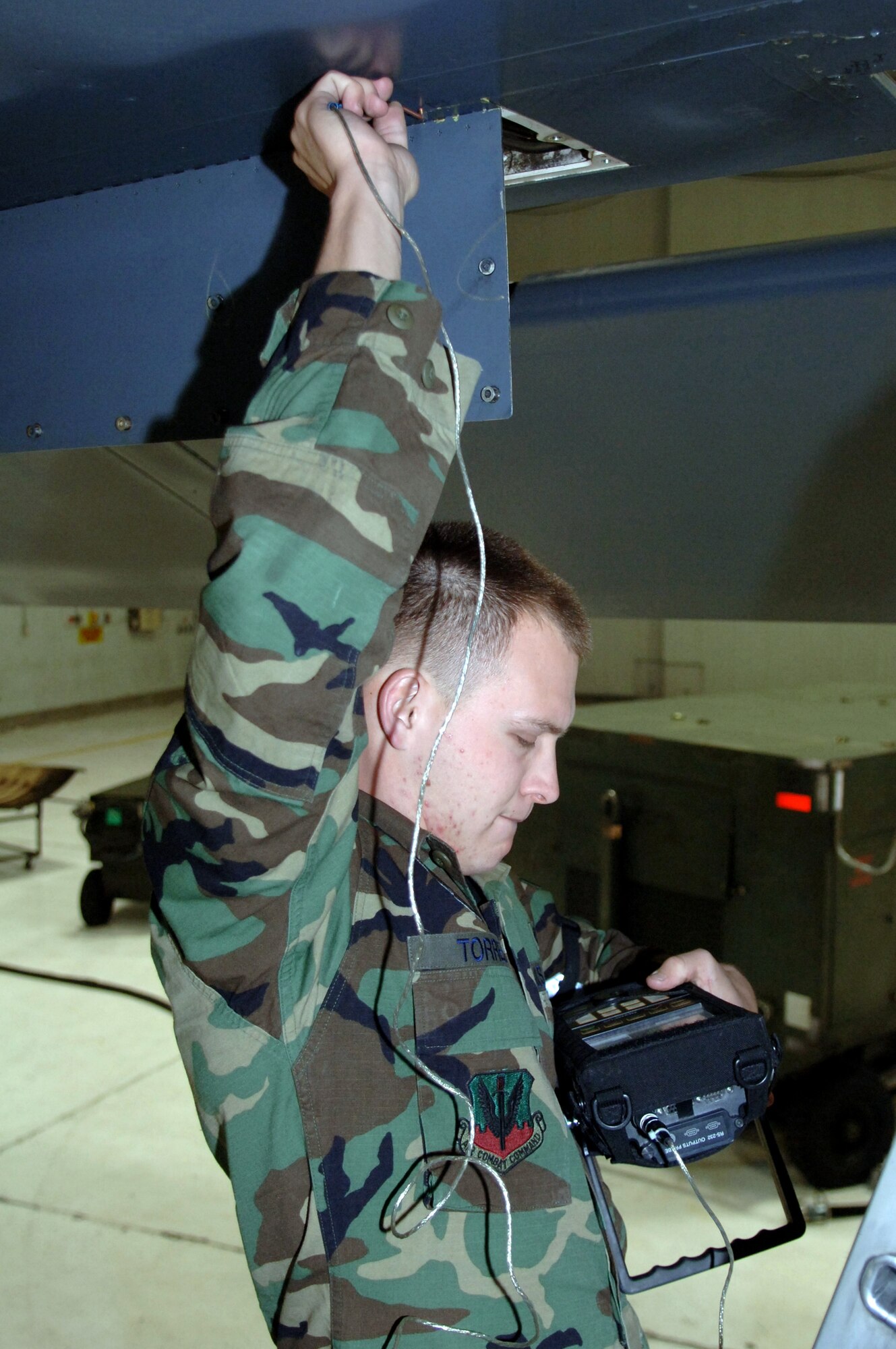 Airman 1st Class Ehud Torres inspects for possible cracks on the B-1B Lancer using the Nortec 2000D March 19 at Ellsworth Air Force Base, S.D. Airman Torres is a nondestructive inspections technician with the 28th Maintenance Squadron. (U.S. Air Force photo/Airman 1st Class Angela Ruiz)