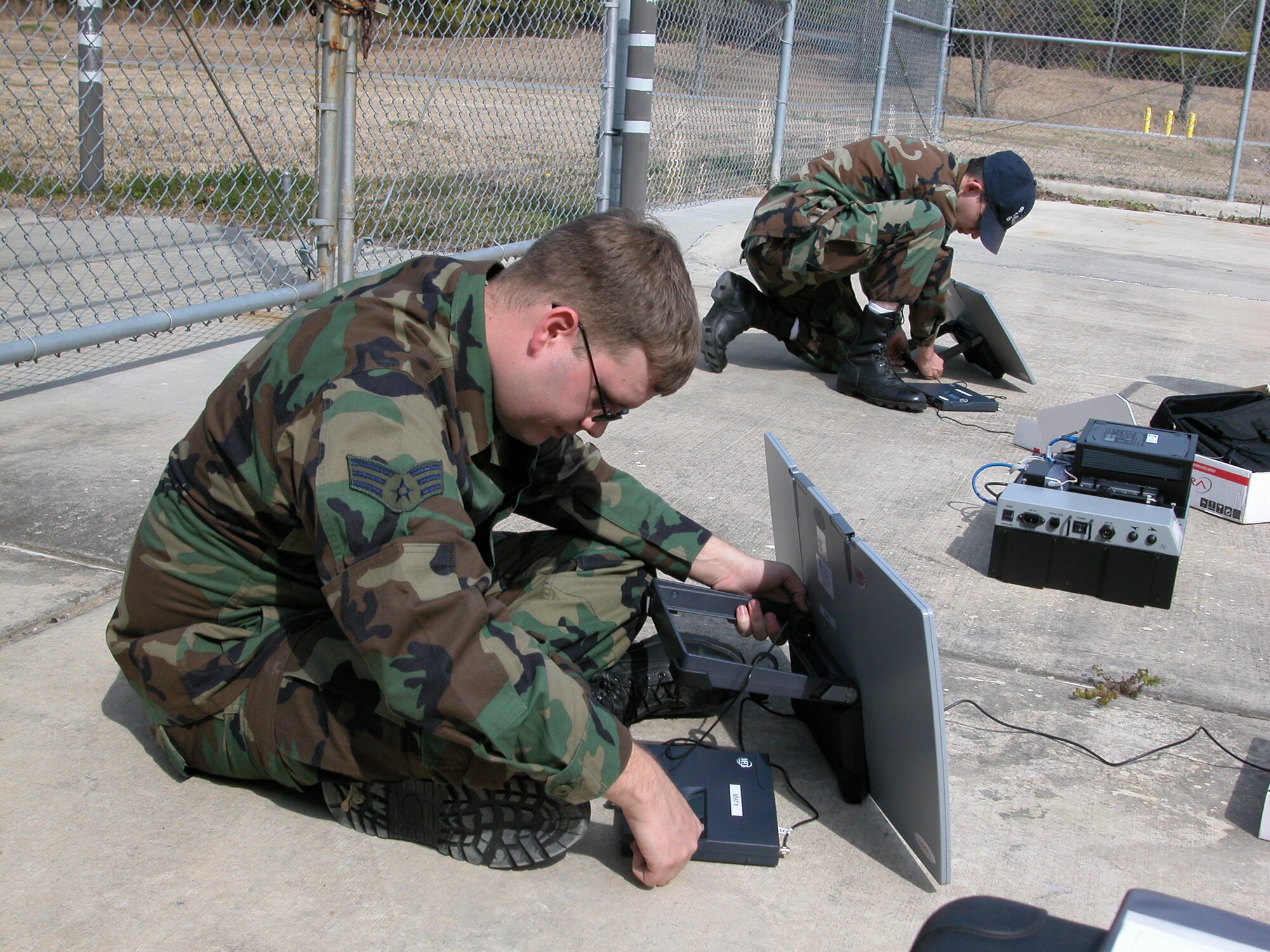 During the March Unit Training Assembly, Senior Airman Robert Lawson and Senior Airman John Lindsay work on satellite communications devices that transmit and receive secure and non-secure voice and data communication. Both reservists are part of the 916th Air Refueling Wing's Communication Squadrons. (U.S. Air Force photo/Staff Sgt. Scott Mathews)          